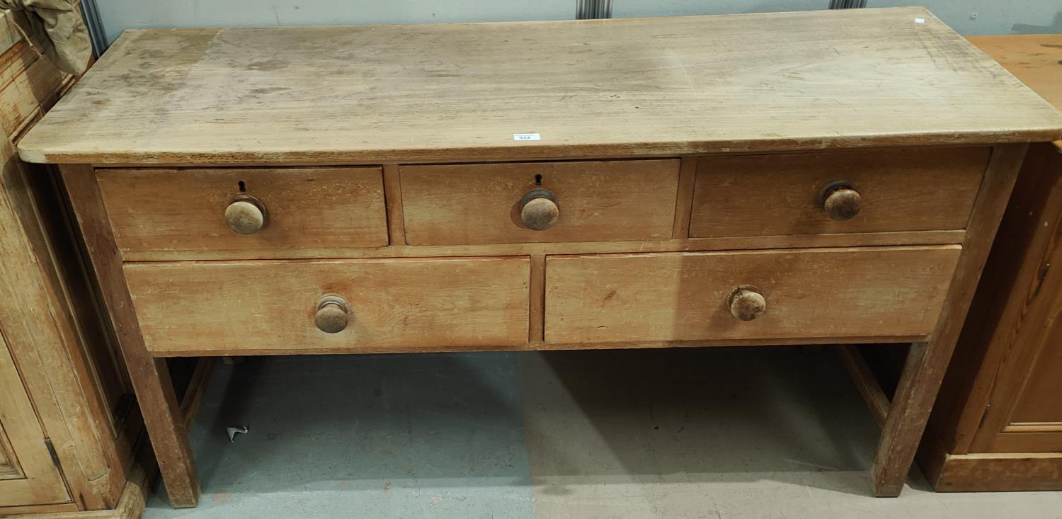 A Victorian stripped pine dresser base of 3 short and 2 long drawers