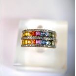 A 9 carat hallmarked dress ring with 3 bands of clear stones and 2 bands of rainbow coloured stones,