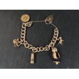 A heavy curb chain charm bracelet with 9 carat hallmarked gold heart lock, 4 charms (2 x 9ct hmg)