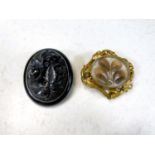 A Victorian mourning brooch with gilt leaf border, hair display, monogrammed reverse, length 5.5cm