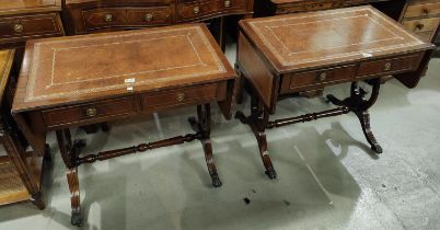 A pair of reproduction mahogany sofa tables with inset leather tops on lyre ends and splay feet