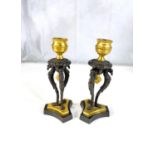 A pair of 19th century gilt and bronze candle sticks on three bird shaped supports