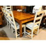 A large rectangular pine dining table, square legs 200 x 90cm with 6 ladder back chairs in white