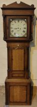 An early 19th century oak and mahogany longcase clock with architectural pediment and turned columns