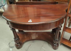 A 19th century demi-lune mahogany side table/wash stand on turned fluted legs