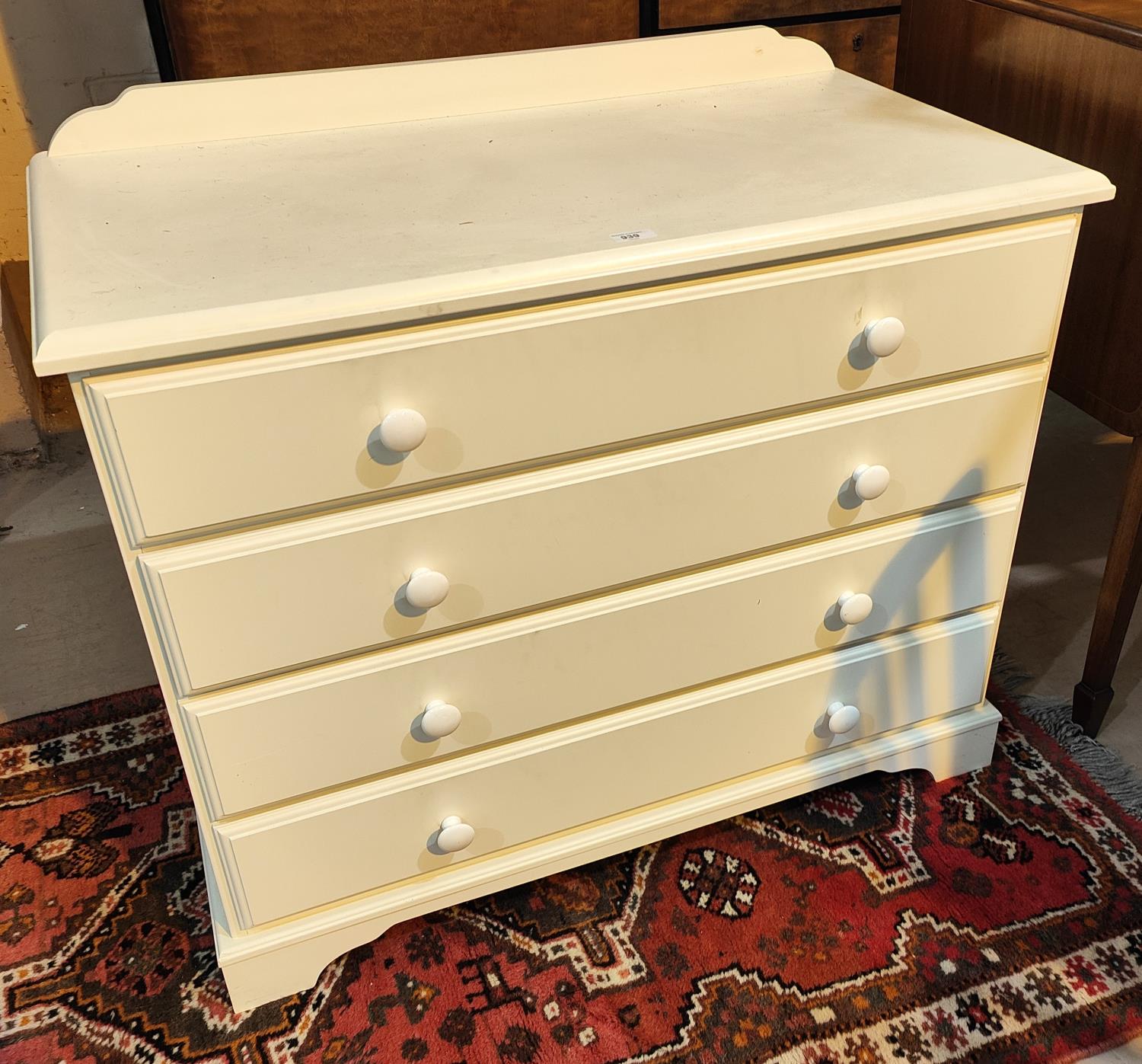 A modern 4 height chest of drawers in white finish