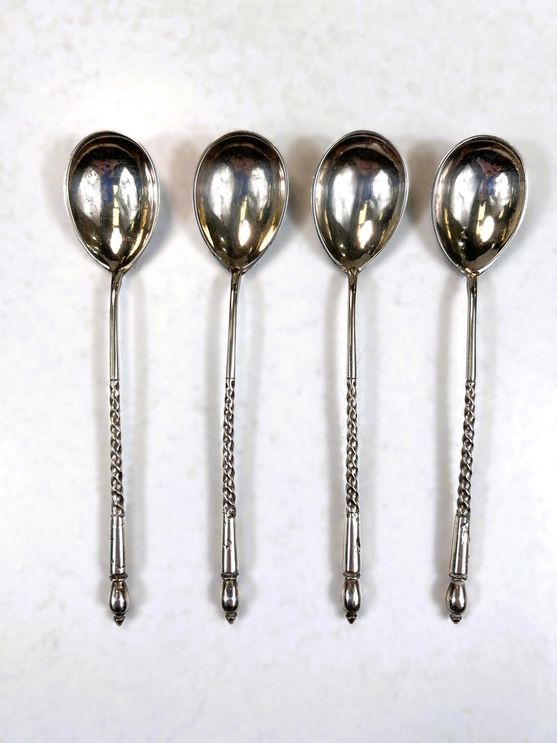 A cased set of 6 silver gilt and coloured enamel coffee spoons, Birmingham 1961; a set of 4