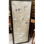 A large Chinese embroidered picture depicting birds in branches, 137 x 51cm framed and glazed