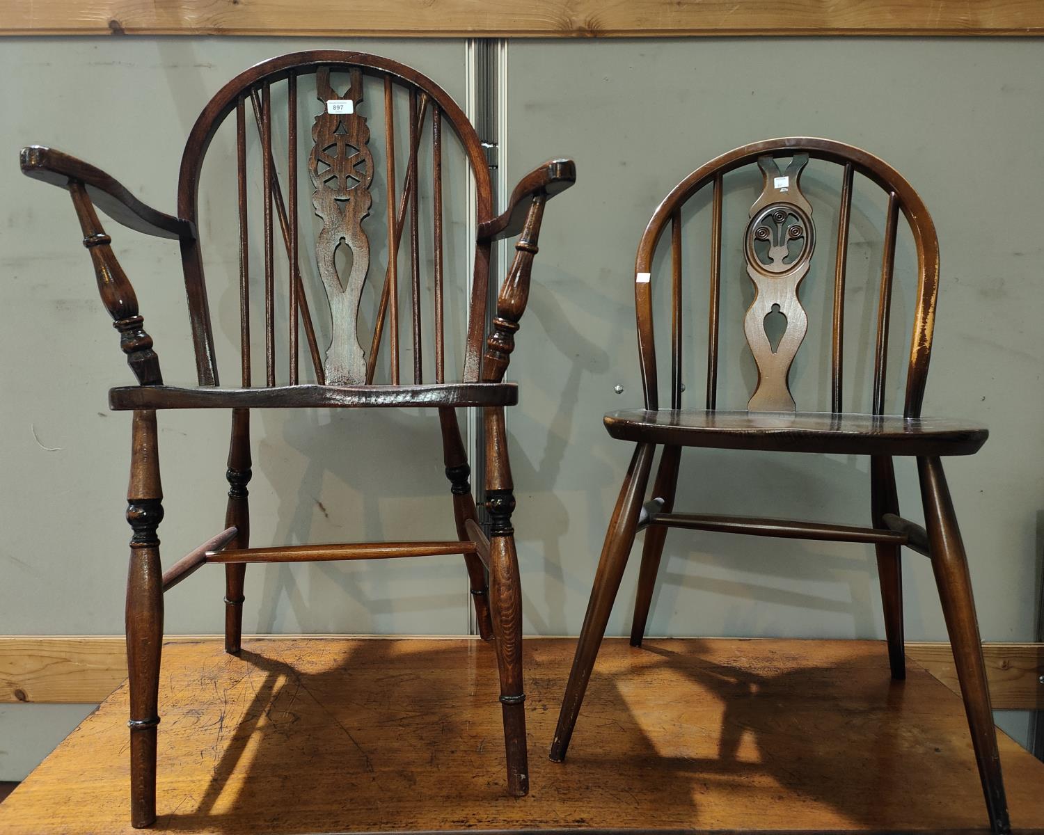 A Windsor wheelback armchair; an Ercol dining chair; an Ercol lightwood stick back rocking chair