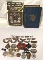 A collection of military shoulder badges and buttons etc and a book on badges