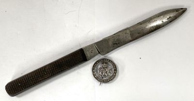 A stainless steel knife with ridged wooden handle A Cox Limited and a WWI wound badge numbered