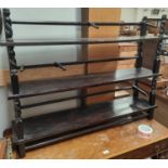 A three tier ebonised mahogany open bookcase