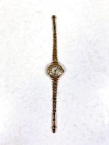 A 9ct hallmarked gold ladies wrist watch on yellow metal strap, strap stamped 9ct, gross weight