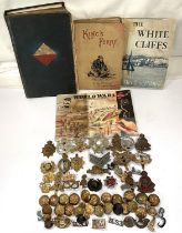 A collection of various military badges etc and military books