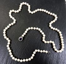 A string of cultured pearls, knotted with 9ct hallmarked white gold clasp set with oval amethyst