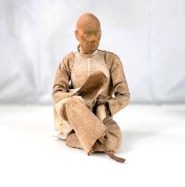 A 19th century Indian Krishnagar figure of a seated man, with detailed face