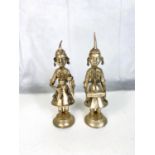 A pair of oriental white coloured metal figures playing instruments, ht. 20cm
