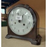 A mid 20th century bakelite cased mantle clock with silvered dial and striking movement by
