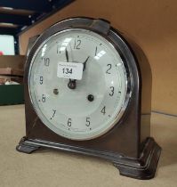 A mid 20th century bakelite cased mantle clock with silvered dial and striking movement by