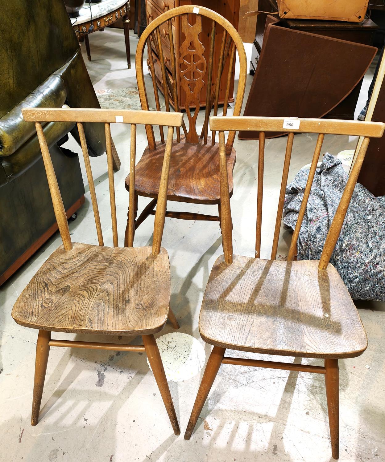 A pair of 1960's Ercol stick back elm dining chairs; a pair of wheel back dining chairs