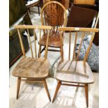 A pair of 1960's Ercol stick back elm dining chairs; a pair of wheel back dining chairs