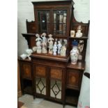 A 19th century full height rosewood side cabinet with mirror back and extensive marquetry inlay, the