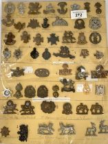 A collection of military regimental badges on card, 'The Gordon Highlanders' etc