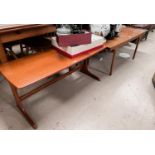 A 1960's rectangular teak coffee table with leaves to each end; a similar table