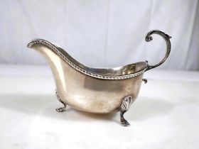 A hallmarked silver sauce boat with 'C' scroll handle and 3 hoof feet, Birmingham 1911, 4oz