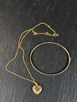 A yellow metal bangle with chevron decoration stamped 375, 4gm; a yellow metal heart pendant stamped