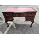 A Georgian style mahogany kneehole desk with inset red leather scriber, gadrooned rim, 5 drawers,