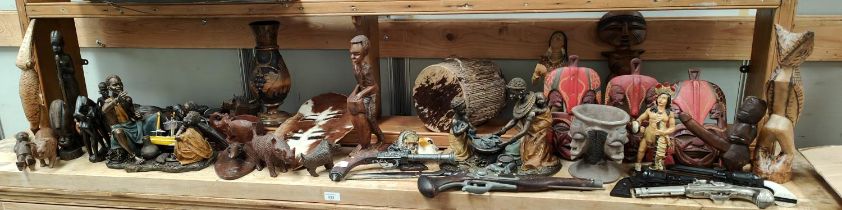 An interesting collection of wooden carved tribal figures, resin and other African figures, hide,