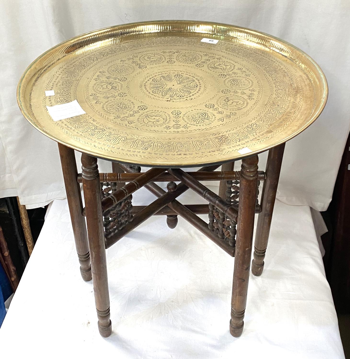 A 19th / 20th century Eastern brass table with folding wood legs - Image 3 of 3
