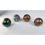 Isle of Wight Glass: four small paperweights with labels, three iridescent lustre with varying