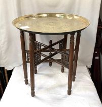 A 19th / 20th century Eastern brass table with folding wood legs