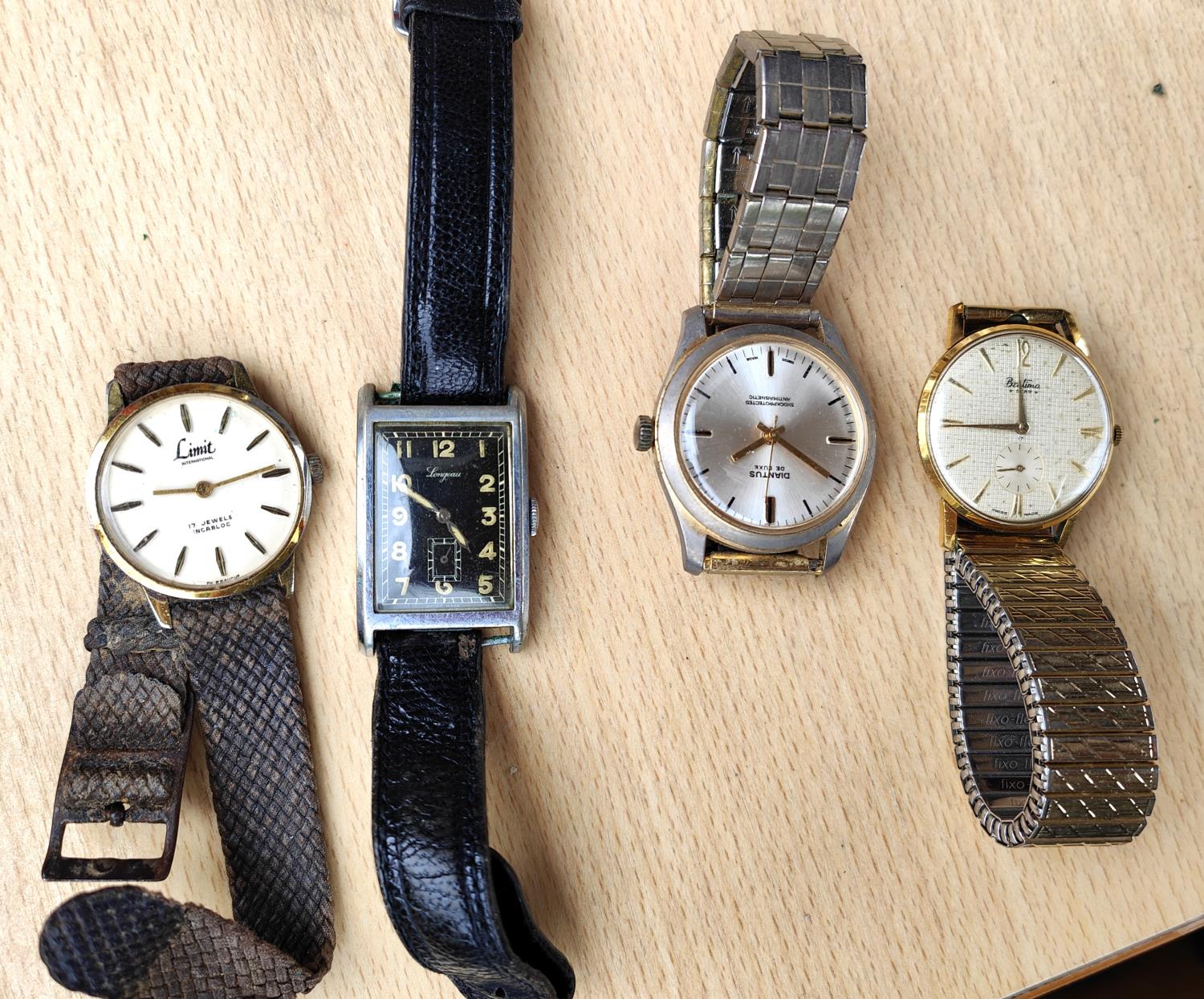 An Art Deco black faced gents rectangular dial wrist watch and three other watches