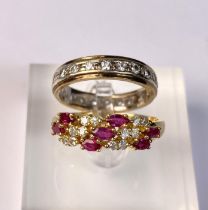 A yellow metal dress ring set with diagonal bands of rubies and diamonds (markes rubbed) 3.9gm, size