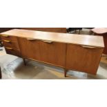 A 1960's teak lowline sideboard by Mackintosh with 3 cupboards and 3 drawers
