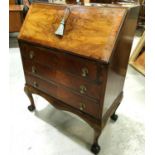 A 1930's walnut fall front bureau with 3 drawers