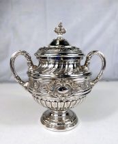 A Rococo style 2 handles covered vase by WMF, having extensive relief decoration, on pedestal