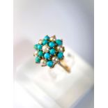 A 9 carat hallmarked gold ring with seed pearls and turquoise in tiered setting, 3.4gm, size N/M