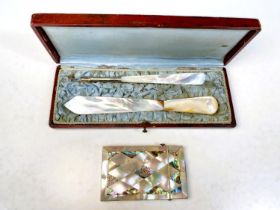 A mother of pearl and abalone shell decorated card case; a boxed mother of pearl letter opener and