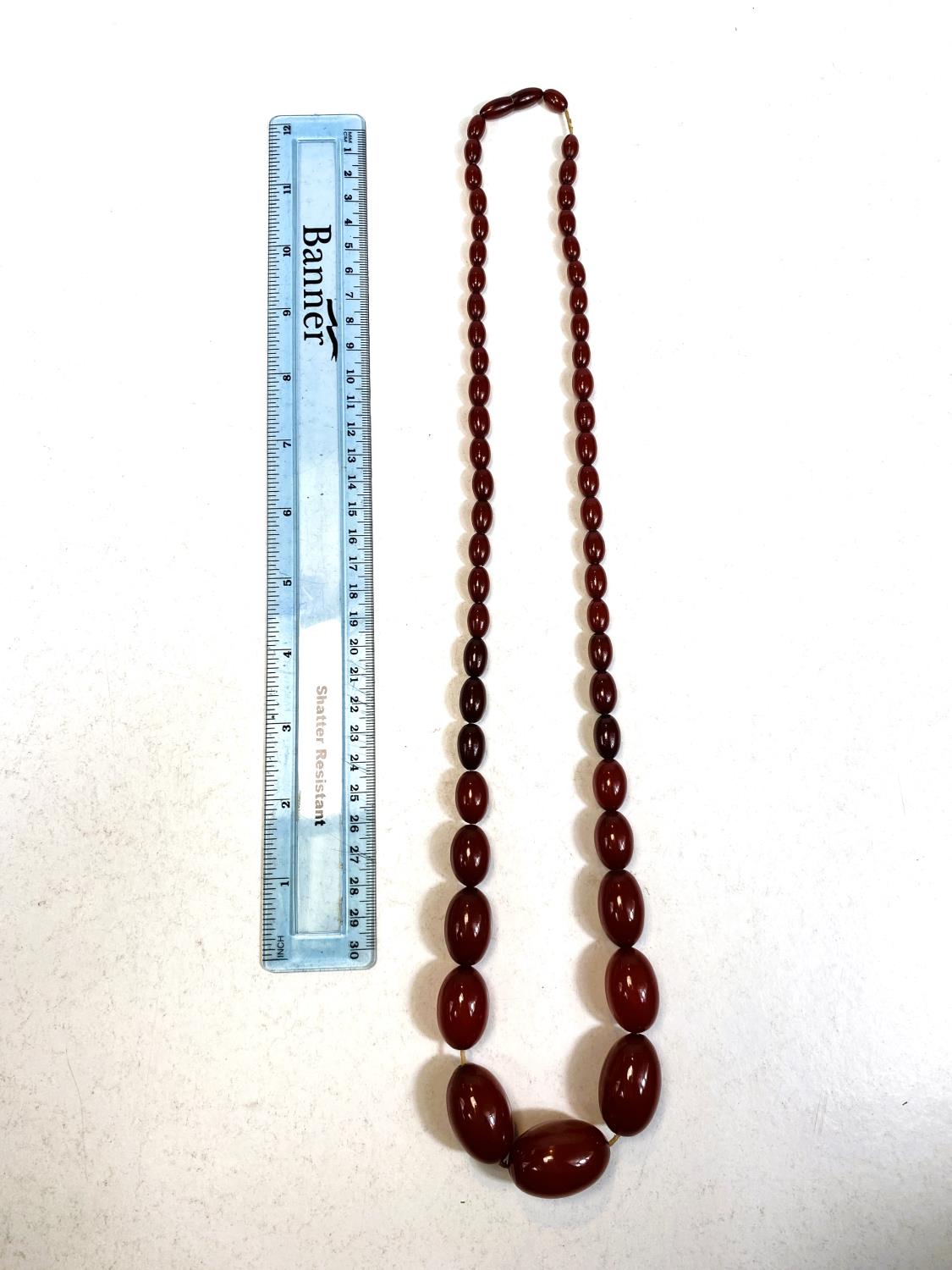 A string of cherry amber bakelite graduating beads, total length 79cm, smallest bead 1cm, largest - Image 3 of 3