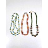 A string of jade green and cloisonne gilt metal beads with faceted garnet spacers, marked JK.NYC,