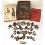 A collection of military badges for various regiments etc and two hardback books