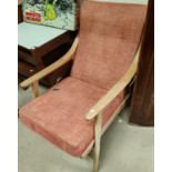 A 1960's lightwood cable sprung armchair in red