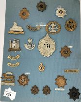 A collection of Military badges on card including various  regiments