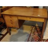A 1970's G-Plan style teak single pedestal desk of 4 drawers