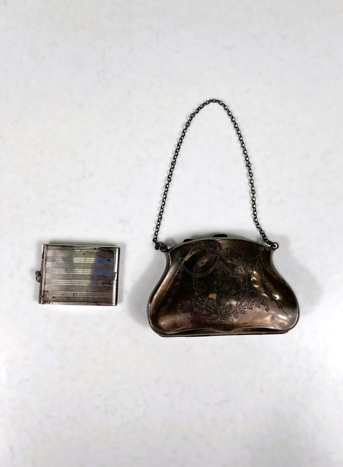 A hallmarked silver purse with chased ribbon and swag decoration, marks worn; an engine turned
