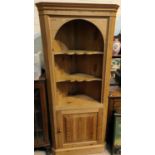 A reproduction pine full height corner cupboard with 3 open shelves and cupboard below